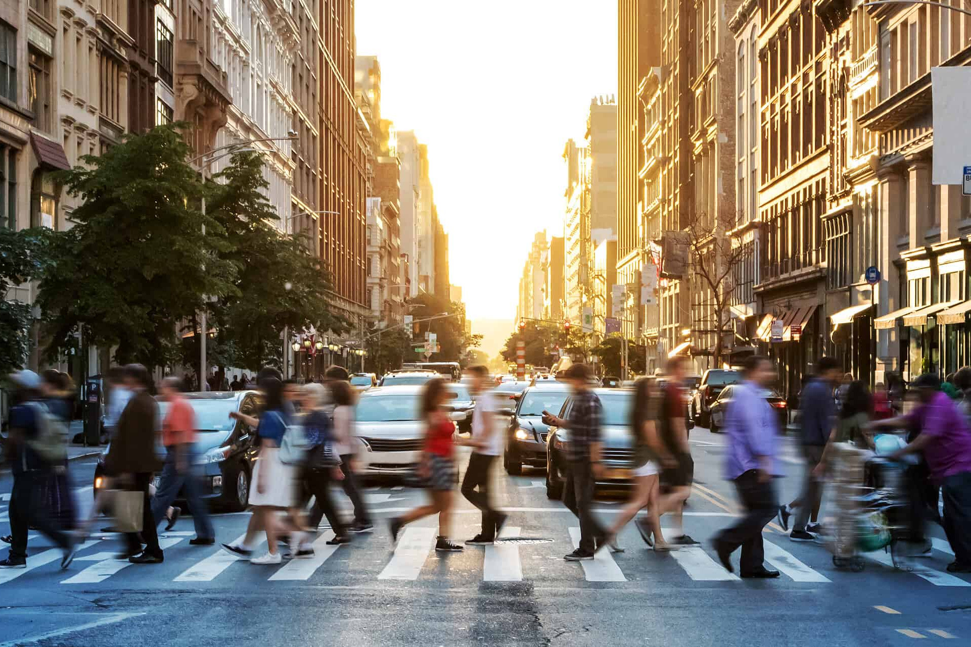 Crowds of people walking across a busy crosswalk at the intersection of 23rd Street and 5th Avenue in Manhattan New York City NYC